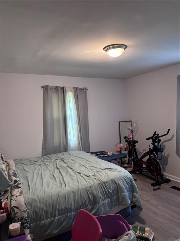 250 Morris Brown Avenue Northwest Atlanta, GA 30314 - Photo 6 of 8 a bedroom with a bed and a chandelier