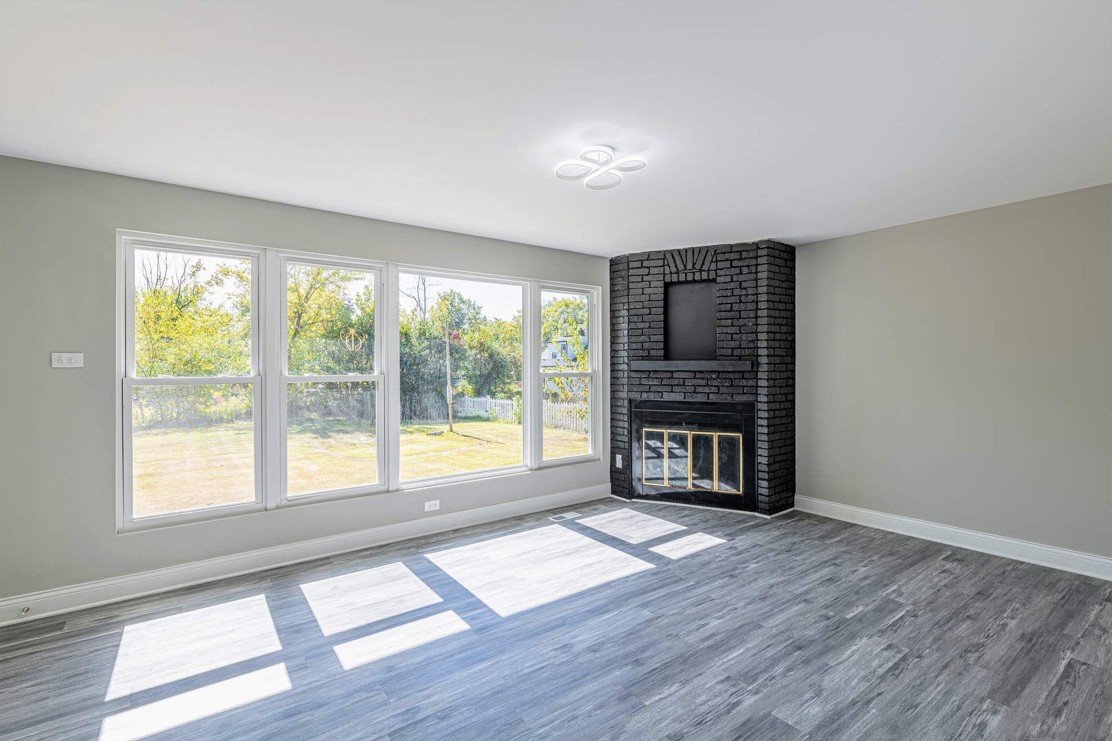 2845 Birch Road Homewood, IL 60430 - Photo 13 of 36 a view of an empty room with a window and wooden floor