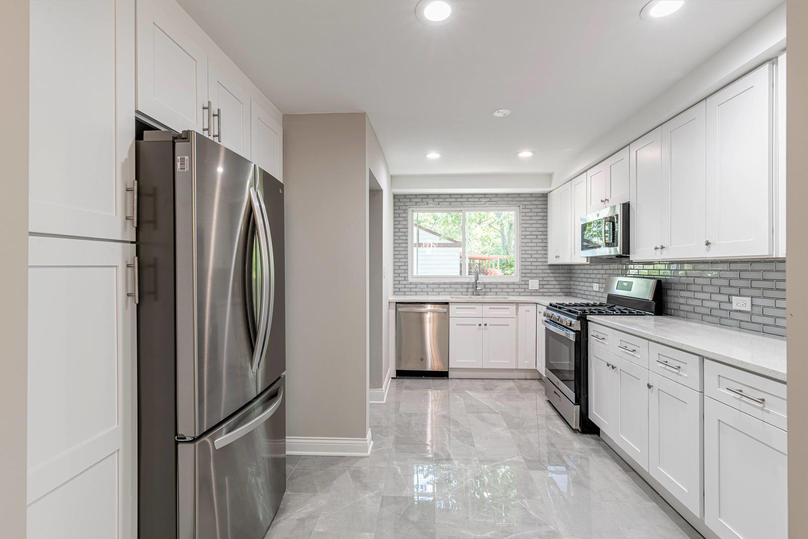 2845 Birch Road Homewood, IL 60430 - Photo 8 of 36 a kitchen with a refrigerator a sink and cabinets