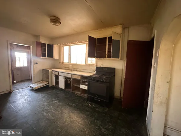 a living room with stainless steel appliances kitchen island granite countertop a refrigerator stove and sink