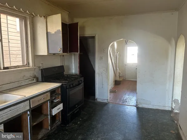 a kitchen with a refrigerator and a stove top oven