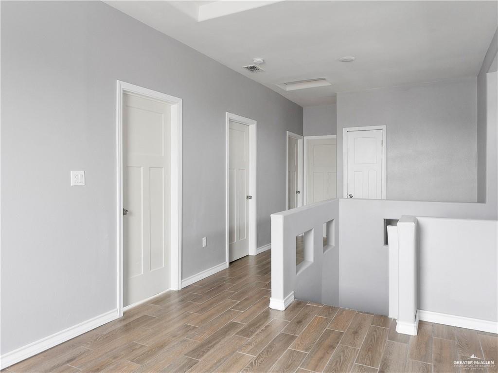 504 Benito Street Rio Grande City, TX 78582 - Photo 14 of 26 a view of an empty room with wooden floor and a cabinet