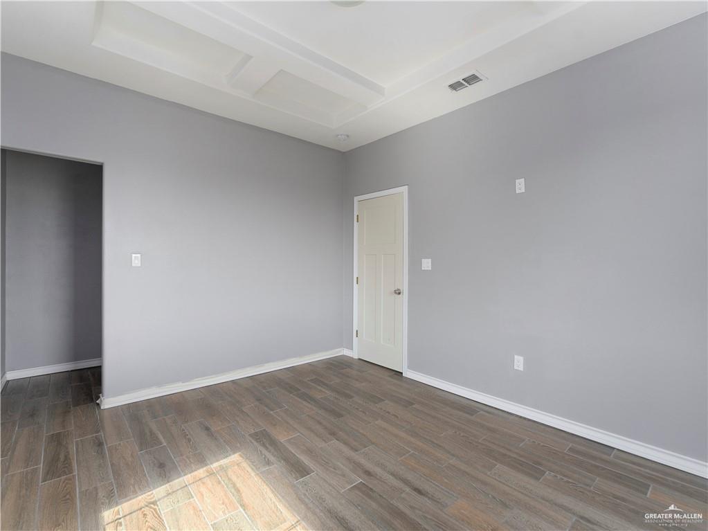 504 Benito Street Rio Grande City, TX 78582 - Photo 17 of 26 a view of an empty room with wooden floor