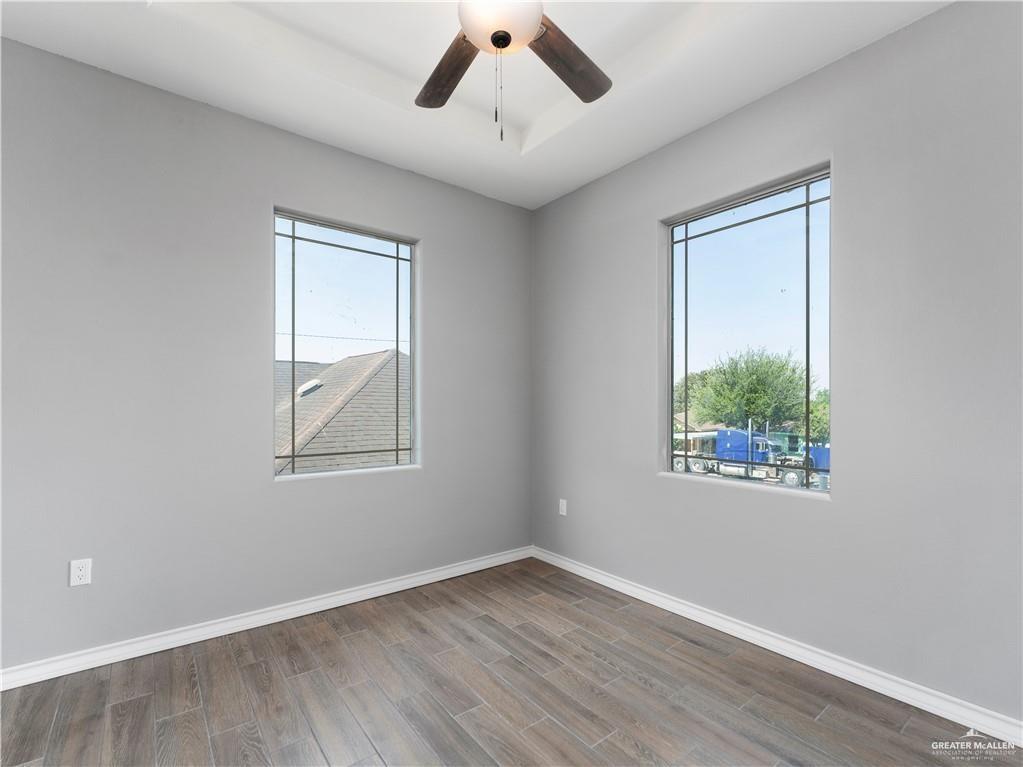 504 Benito Street Rio Grande City, TX 78582 - Photo 20 of 26 a view of an empty room with wooden floor and a window
