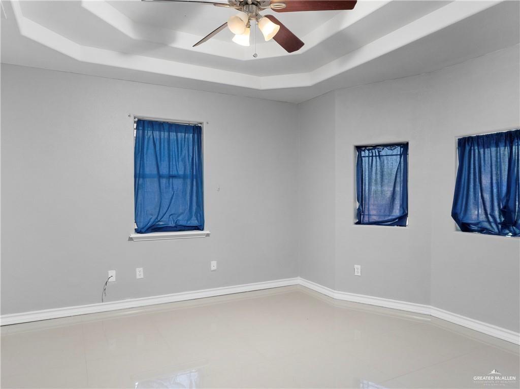 504 Benito Street Rio Grande City, TX 78582 - Photo 7 of 26 an empty room with windows and fan