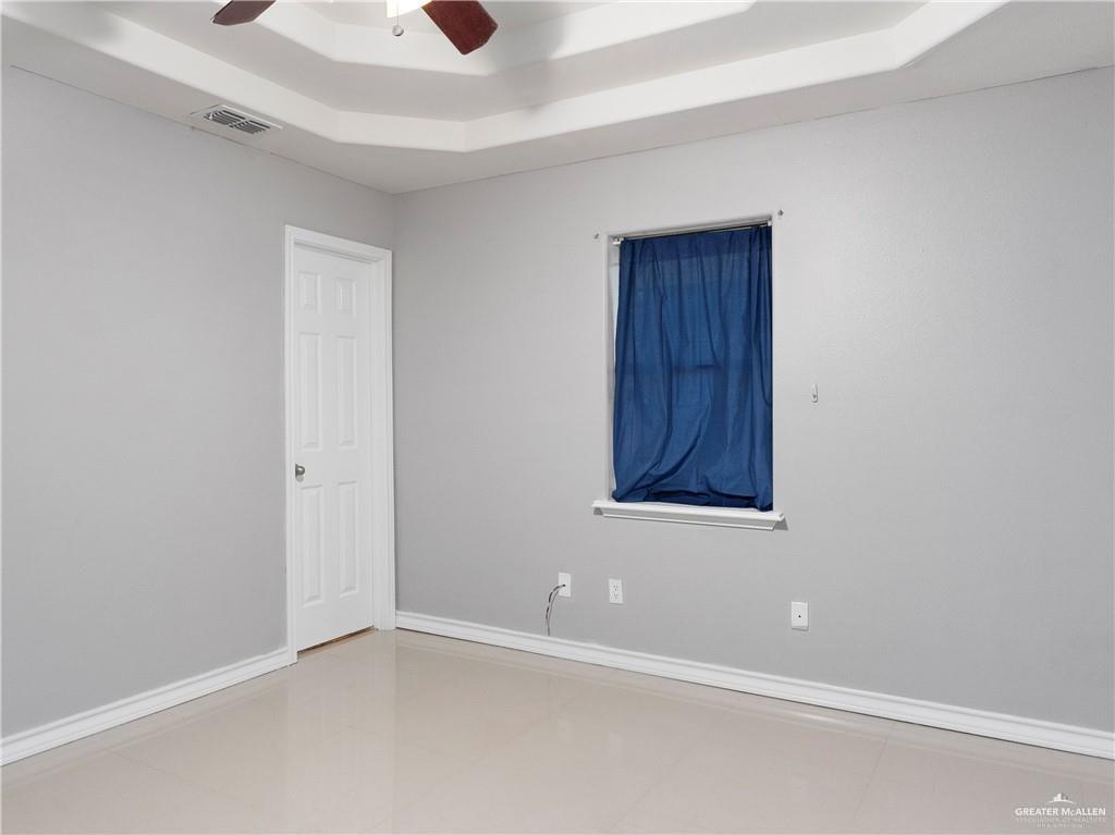 504 Benito Street Rio Grande City, TX 78582 - Photo 9 of 26 an empty room with windows and cabinet