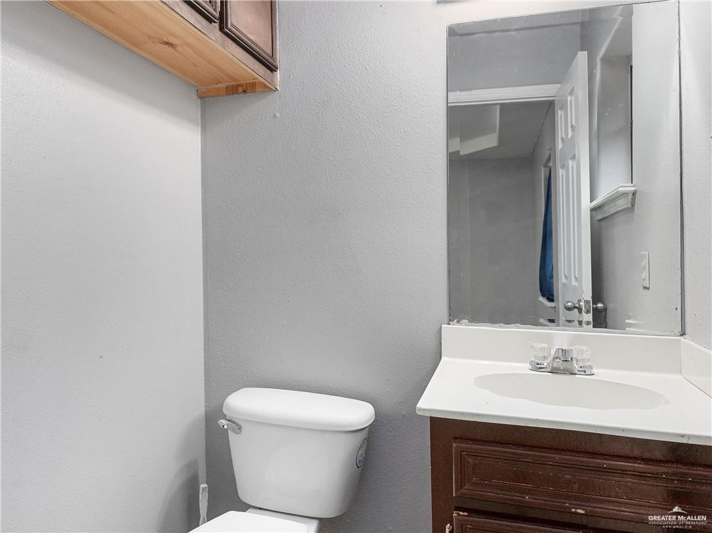 504 Benito Street Rio Grande City, TX 78582 - Photo 10 of 26 a bathroom with a sink a toilet and a mirror