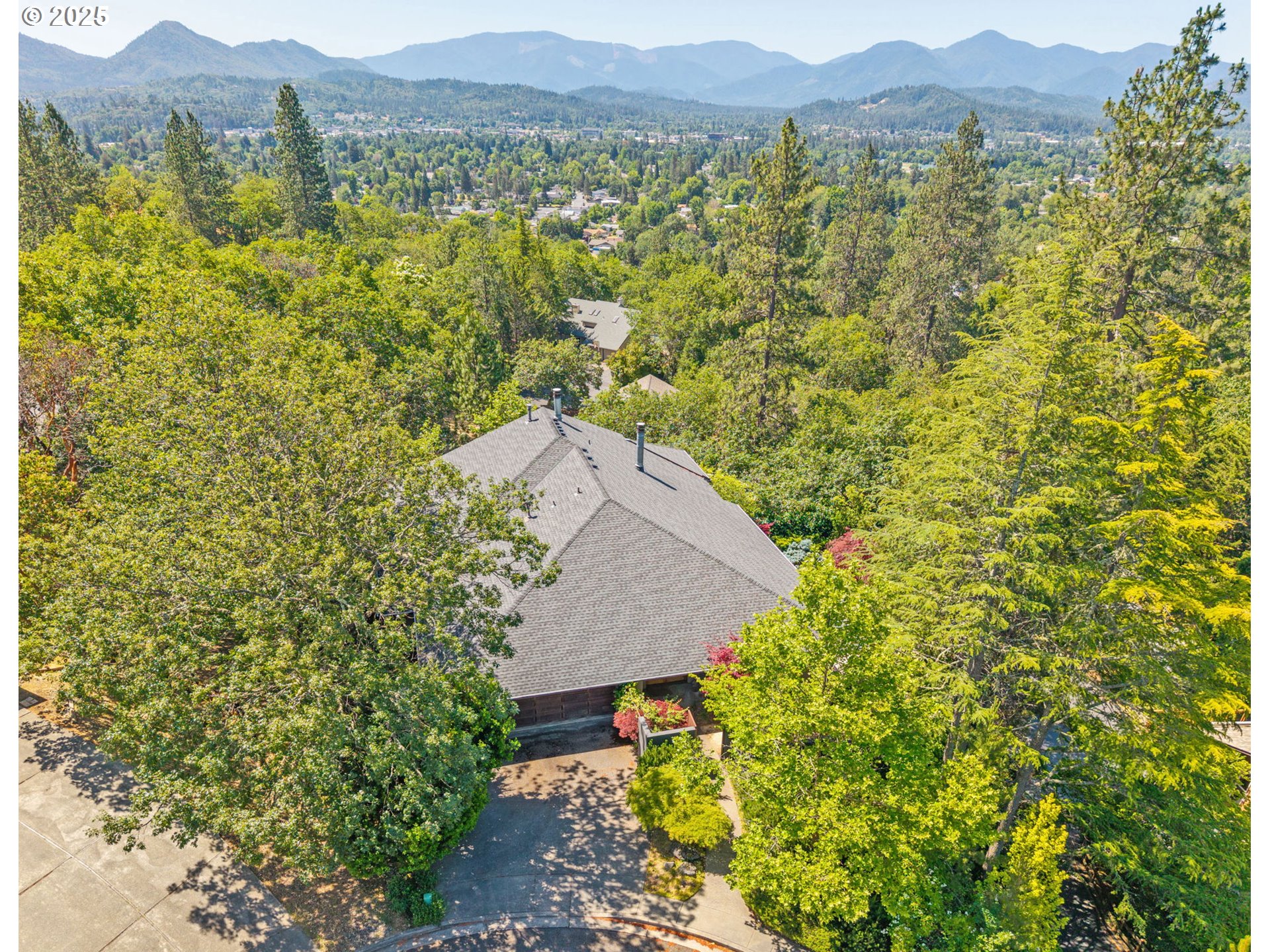 1630 Northwest Olmar Drive Grants Pass, OR 97526 - Photo 28 of 42 a view of a lush green field with mountains in the background