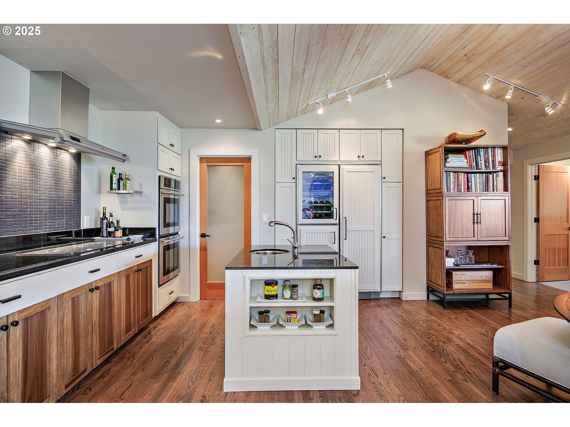 1630 Northwest Olmar Drive Grants Pass, OR 97526 - Photo 9 of 42 a kitchen with stainless steel appliances kitchen island hardwood floor sink stove and refrigerator