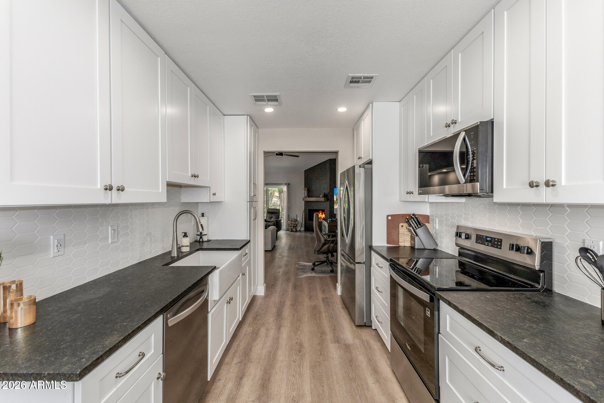 11629 North 40th Way Phoenix, AZ 85028 - Photo 14 of 47 a kitchen with stainless steel appliances granite countertop a sink stove microwave and cabinets