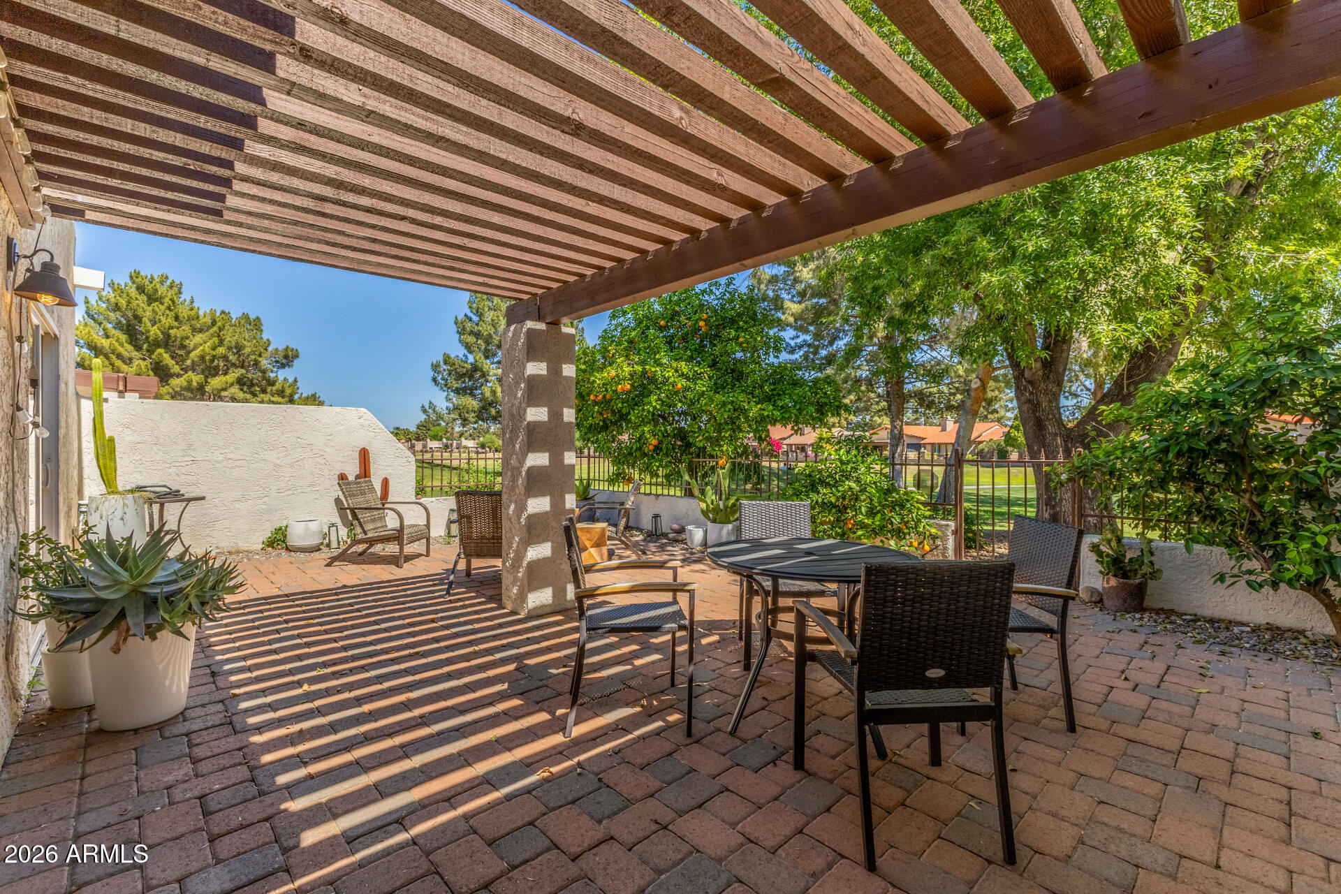 11629 North 40th Way Phoenix, AZ 85028 - Photo 2 of 47 a view of a patio with table and chairs and potted plants