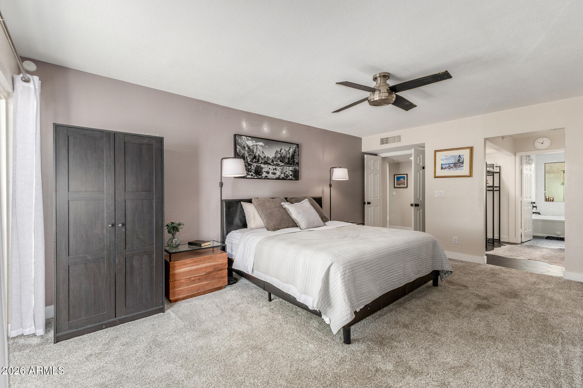 11629 North 40th Way Phoenix, AZ 85028 - Photo 21 of 47 a bedroom with a bed and a chandelier