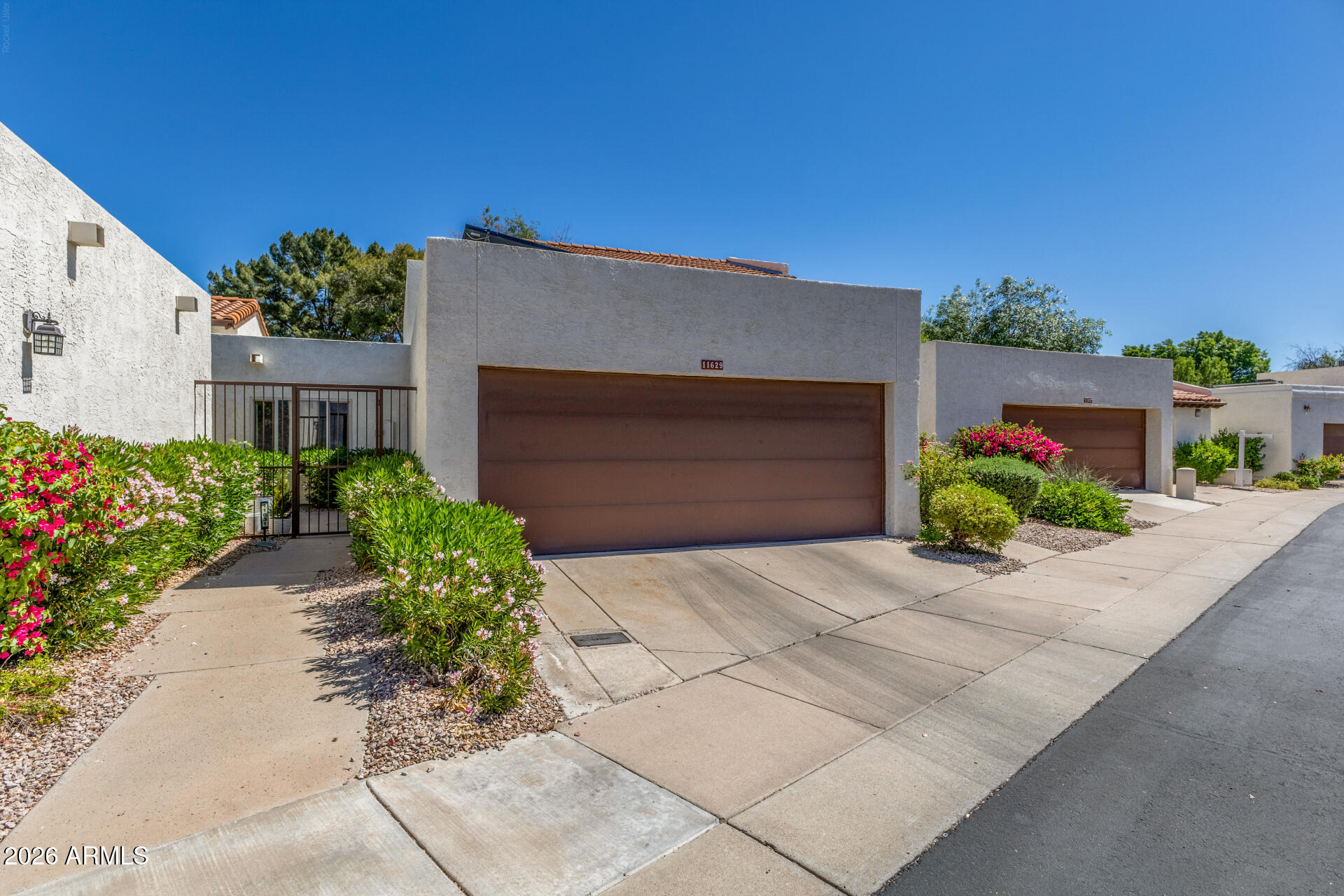 11629 North 40th Way Phoenix, AZ 85028 - Photo 3 of 47 a front view of a house with potted plants