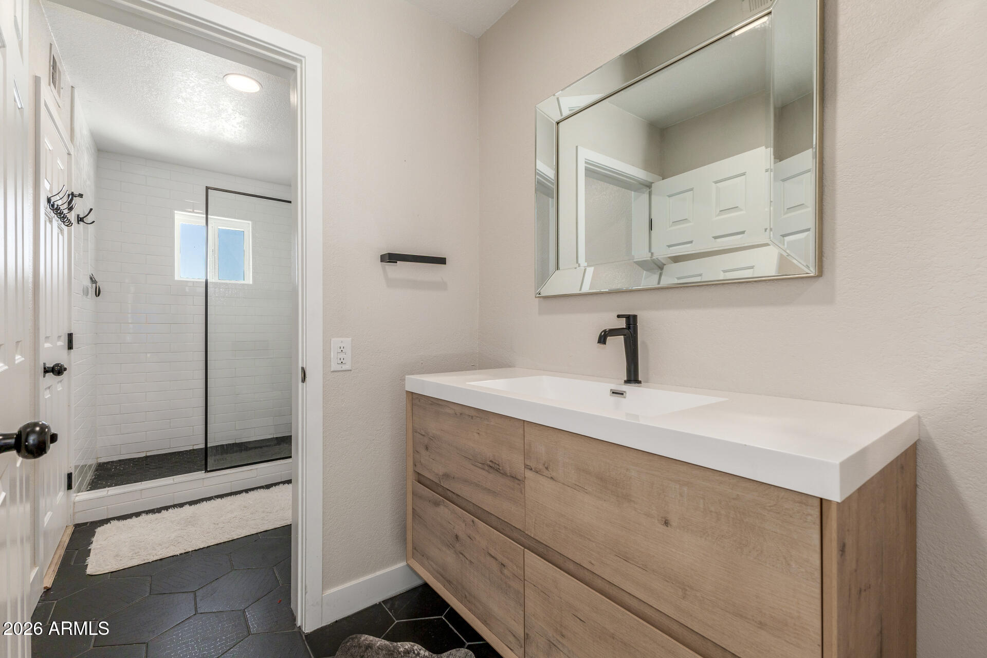 11629 North 40th Way Phoenix, AZ 85028 - Photo 33 of 47 a bathroom with a sink a mirror and a shower