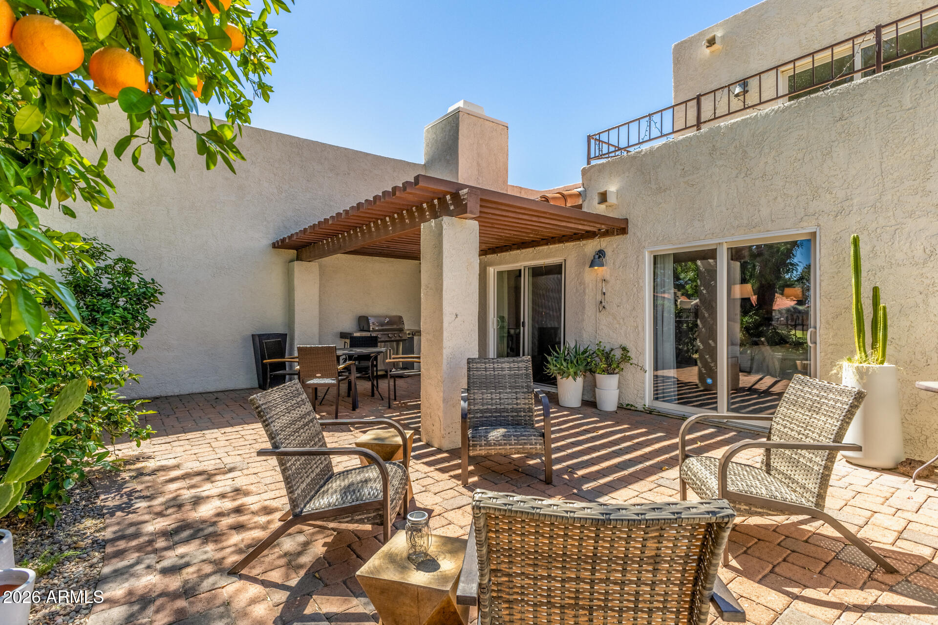 11629 North 40th Way Phoenix, AZ 85028 - Photo 41 of 47 a view of a patio with table and chairs potted plants and floor to ceiling window and potted plants