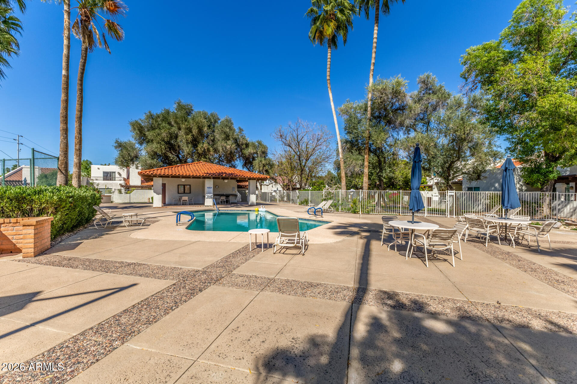 11629 North 40th Way Phoenix, AZ 85028 - Photo 43 of 47 a view of a patio with a table and chairs under an umbrella