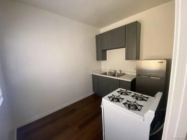 a view of an empty room and wooden floor