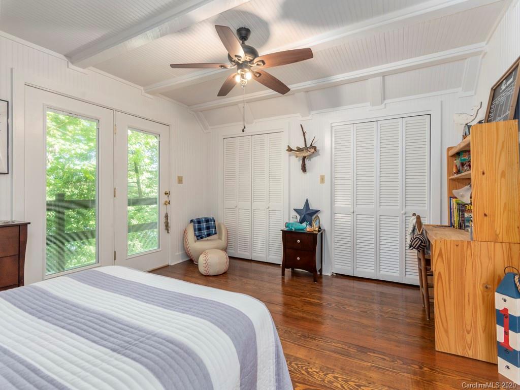 186 Terrell Cove Road Canton, NC 28716 - Photo 14 of 46 a bedroom with a bed and a chandelier