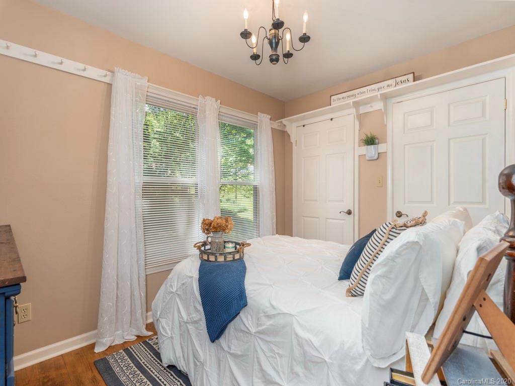 186 Terrell Cove Road Canton, NC 28716 - Photo 8 of 46 a bedroom with a bed and a window