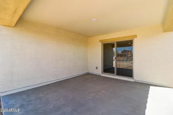 a view of a livingroom with a flat screen tv kitchen view and a fireplace