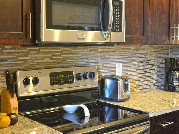 a kitchen with stove and cabinets
