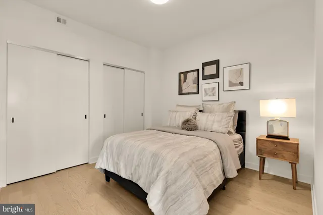 a bedroom with a bed and a lamp