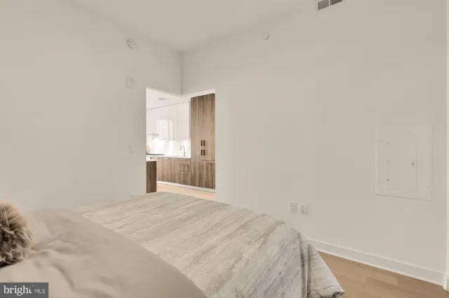 a view of empty room with wooden floor