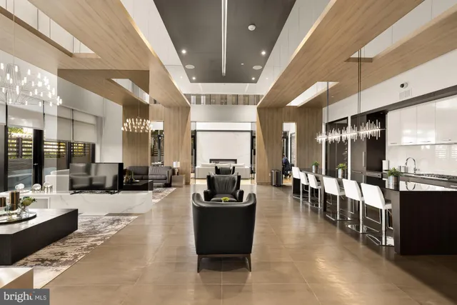 a lobby with furniture and view of living room