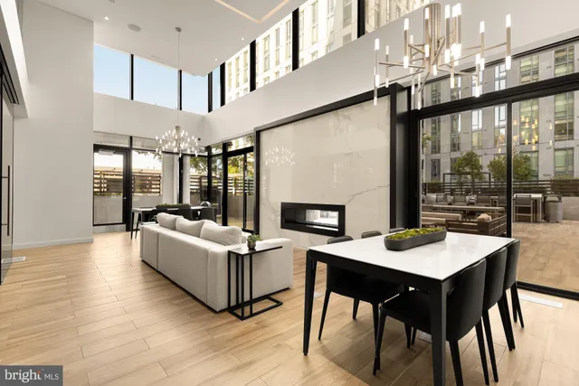 a living room with furniture a table and a large window