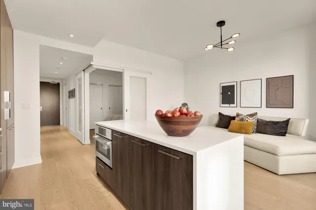 a living room with furniture and a chandelier