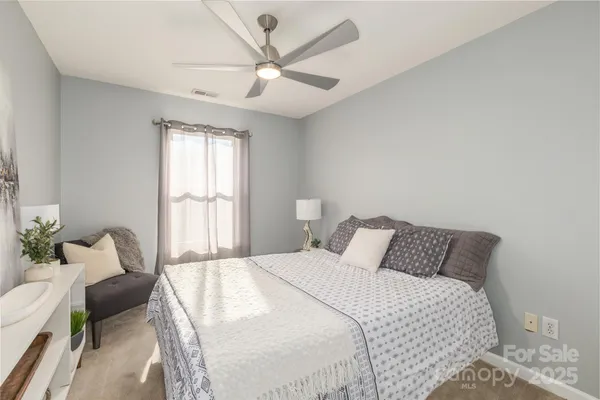 a living room with furniture and flowers