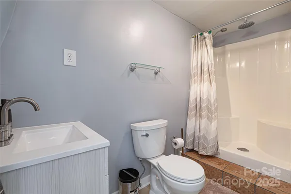 a view of balcony with wooden floor and seating space
