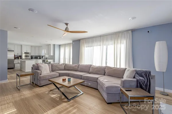 a living room with furniture and a chandelier
