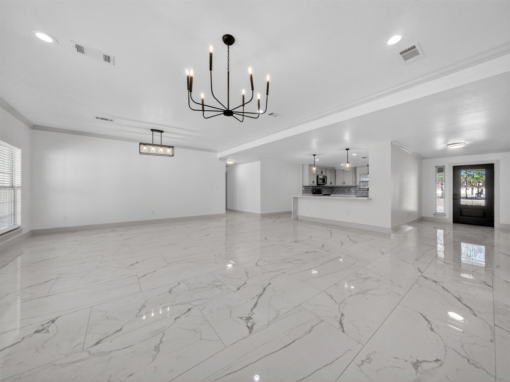 19502 Balsas Drive Porter, TX 77365 - Photo 11 of 44 Picture holidays, game nights, and everyday hangouts in this light-filled living and dining space with raised ceilings, crown molding, and updated tile floors throughout.