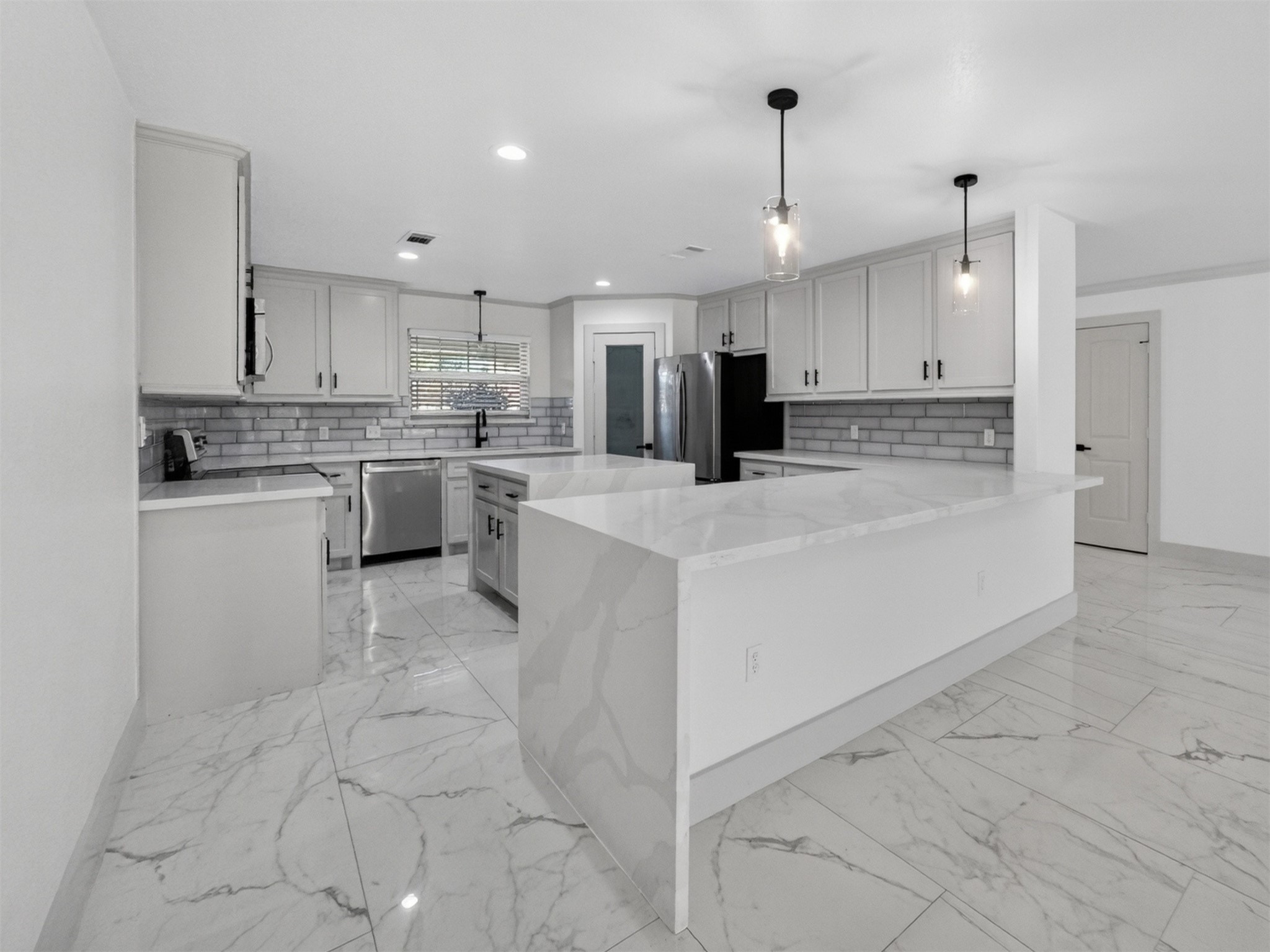 19502 Balsas Drive Porter, TX 77365 - Photo 14 of 44 Quartz counters, sleek waterfall peninsula, bar seating for five—and yes, there’s a pantry. This kitchen is made for people who love to cook, chat, and snack.