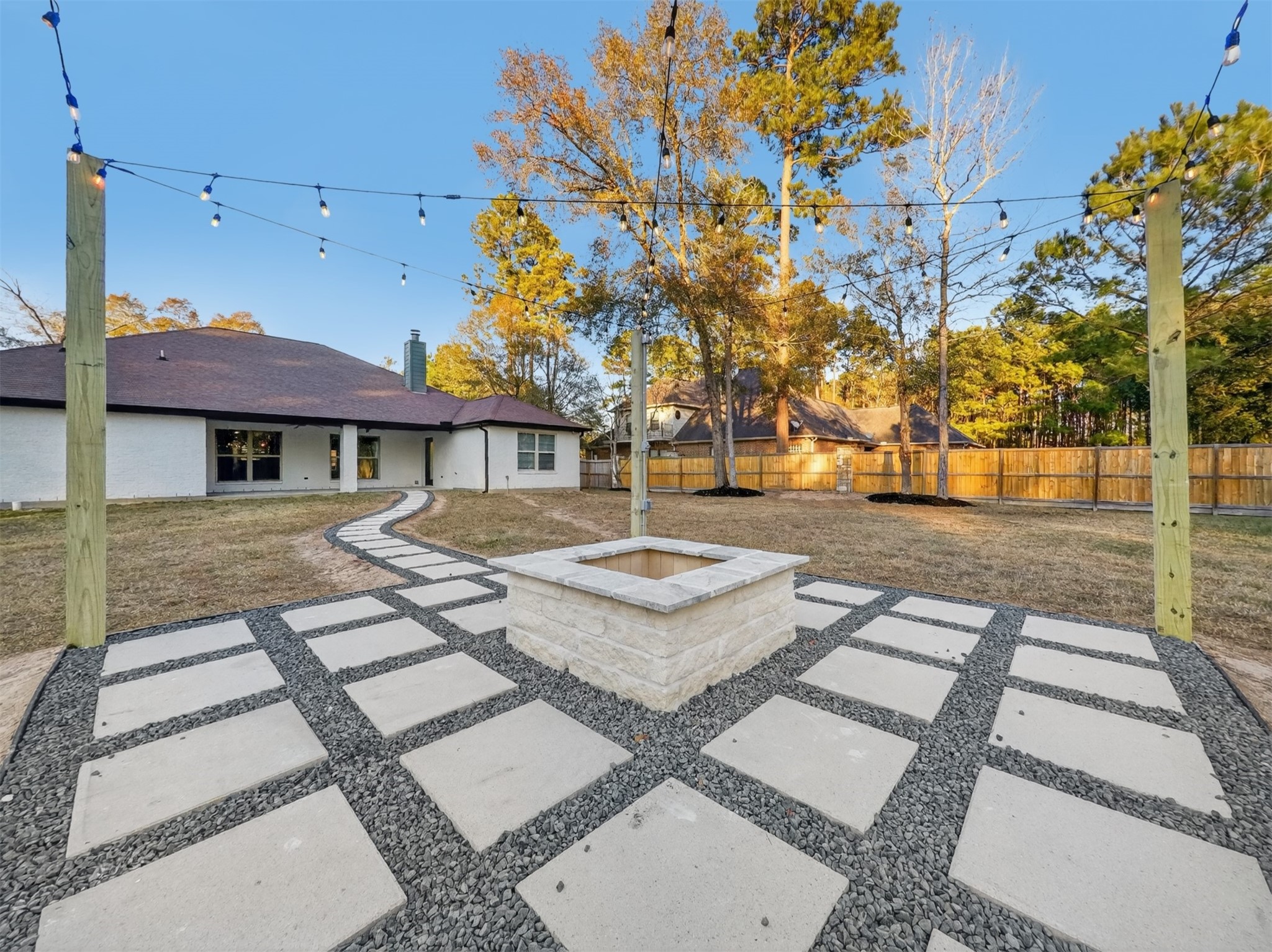 19502 Balsas Drive Porter, TX 77365 - Photo 37 of 44 Cozy nights under the stars start here—gather ‘round the firepit and let the day fade away.
