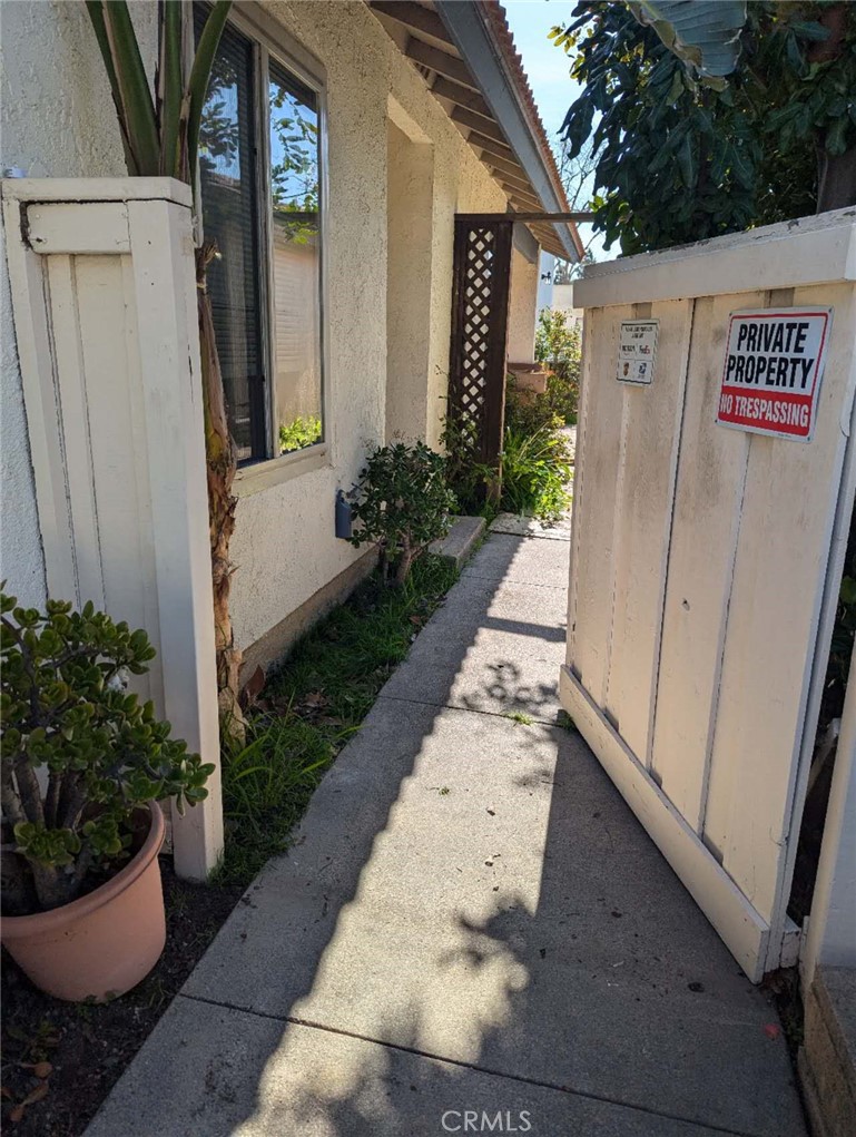 64 Tangerine Irvine, CA 92618 - Photo 5 of 32 a view of a entryway door with flower plants in front of main door