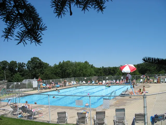 a view of a swimming pool with a table and chairs