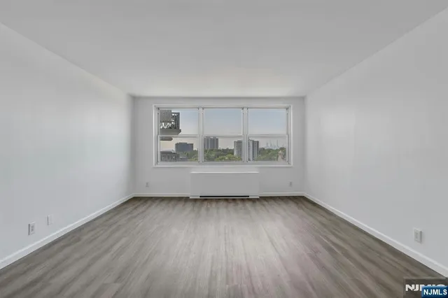 a view of room with window and hardwood floor