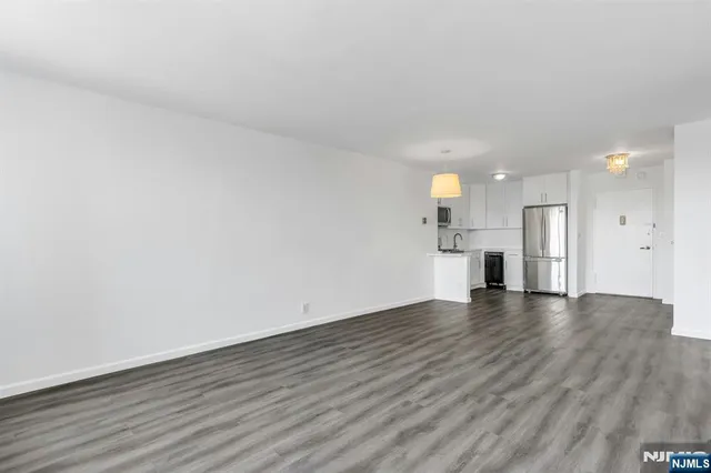 a view of a kitchen with a sink and a refrigerator