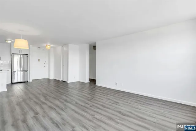a view of wooden floor and windows in a room