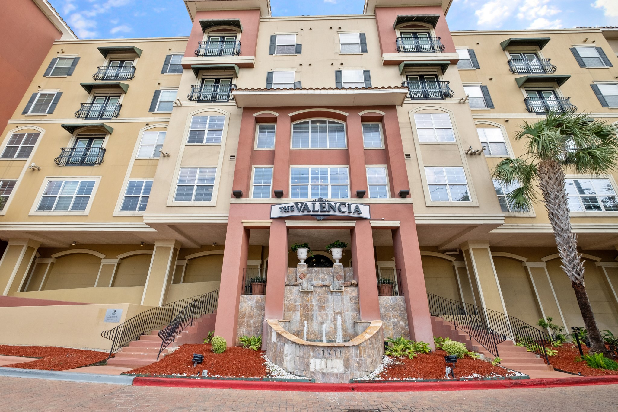 a front view of a building with a fountain