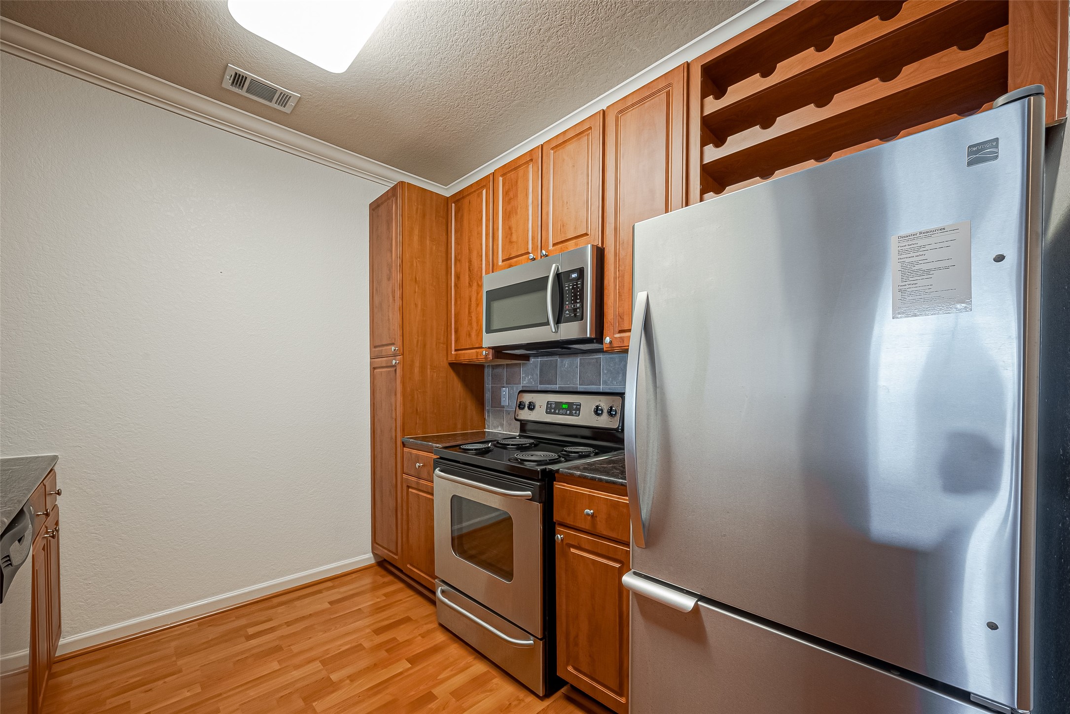 1711 Old Spanish Trail, Unit 303 Houston, TX 77054 - Photo 12 of 37 a kitchen with stainless steel appliances a refrigerator and a stove top oven