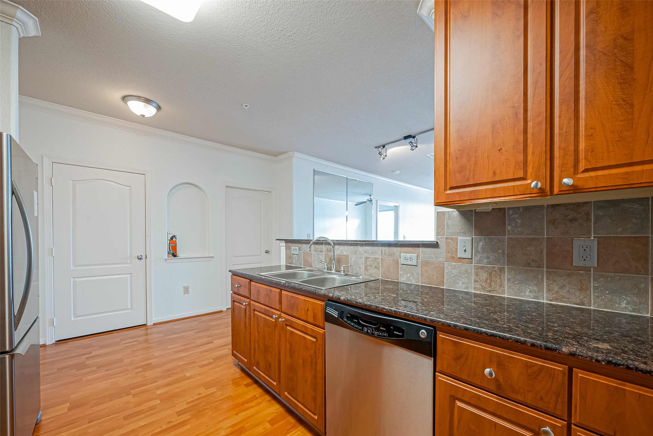 1711 Old Spanish Trail, Unit 303 Houston, TX 77054 - Photo 14 of 37 a kitchen with stainless steel appliances granite countertop a sink stove and cabinets