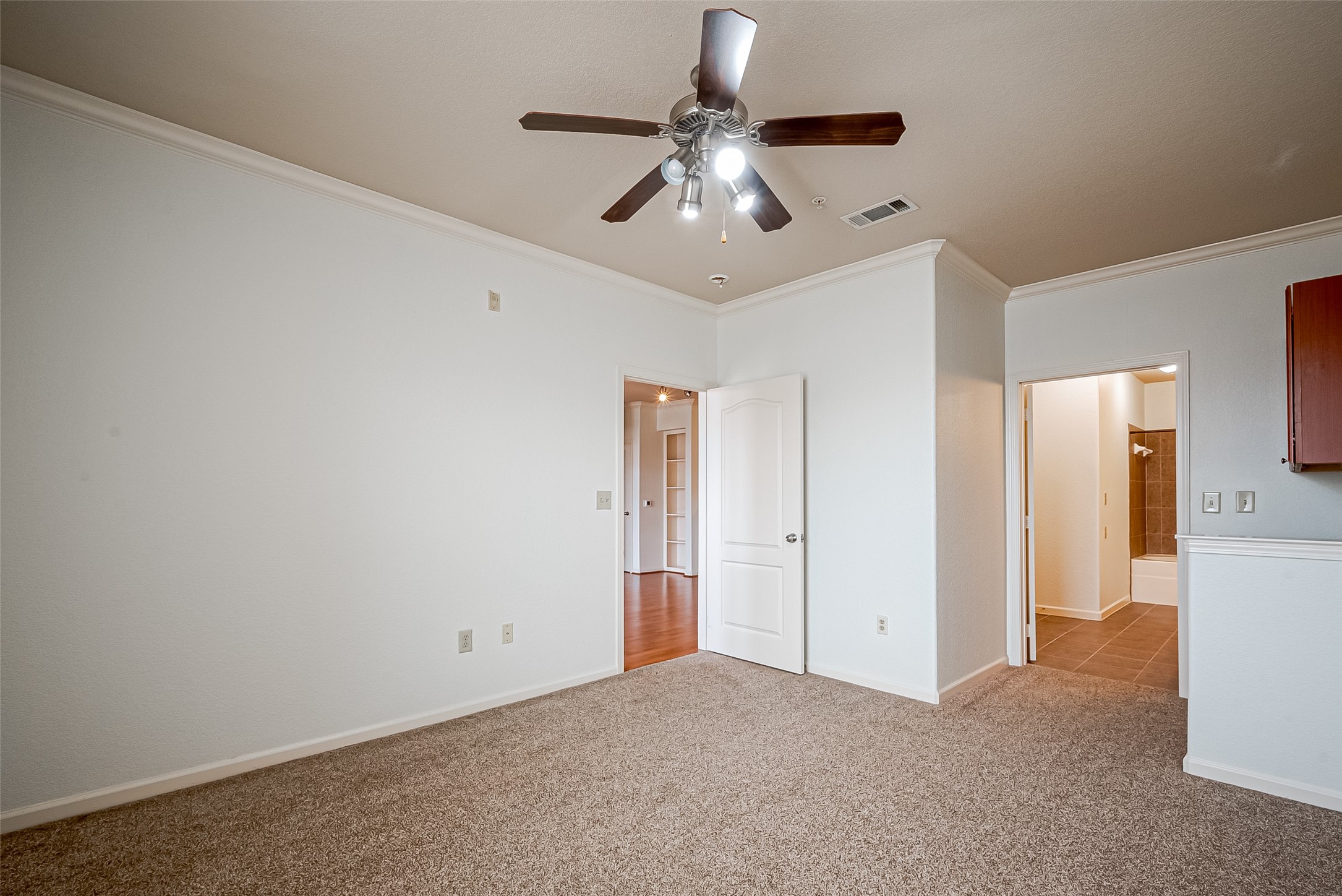 1711 Old Spanish Trail, Unit 303 Houston, TX 77054 - Photo 19 of 37 a view of an empty room with a chandelier fan