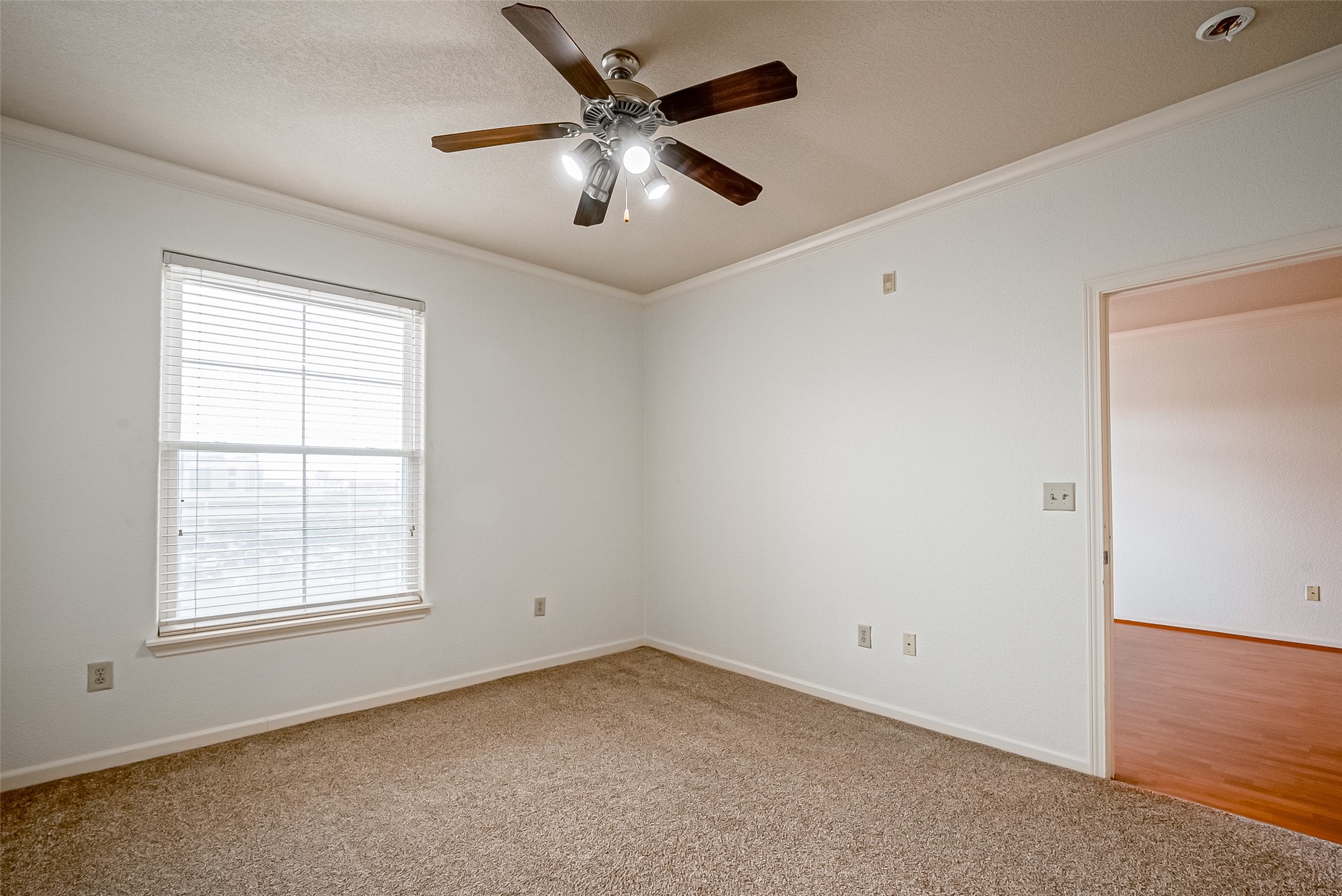 1711 Old Spanish Trail, Unit 303 Houston, TX 77054 - Photo 20 of 37 an empty room with a window and a fan