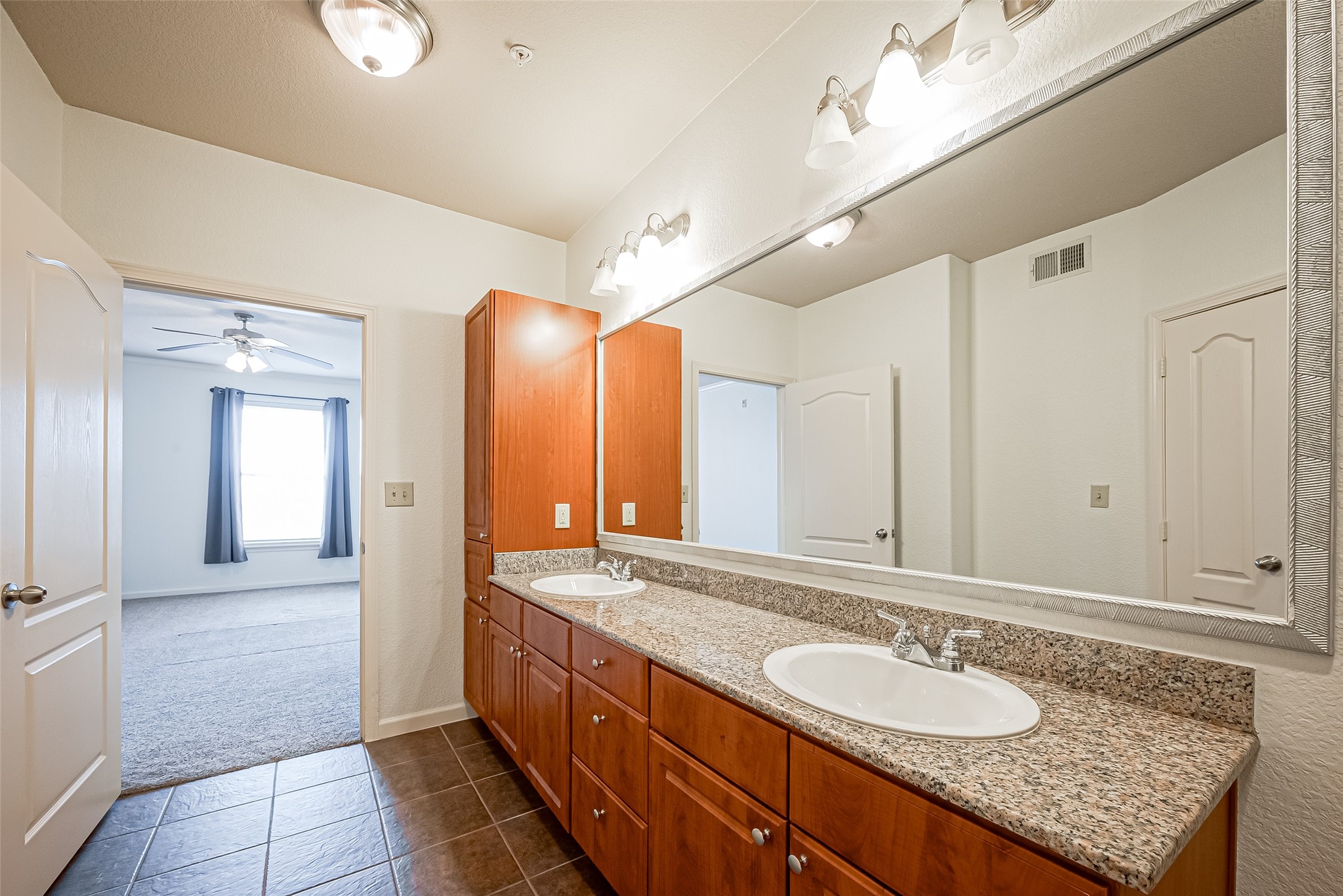 1711 Old Spanish Trail, Unit 303 Houston, TX 77054 - Photo 28 of 37 a bathroom with a granite countertop sink and a mirror