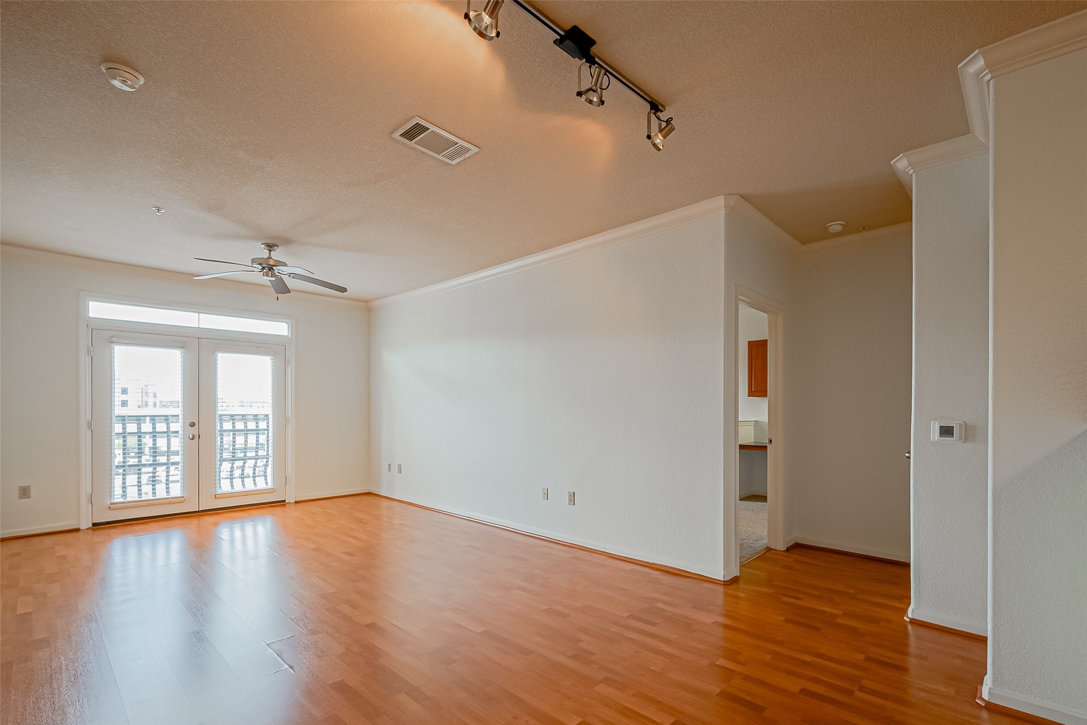 1711 Old Spanish Trail, Unit 303 Houston, TX 77054 - Photo 5 of 37 wooden floor in an empty room with a window