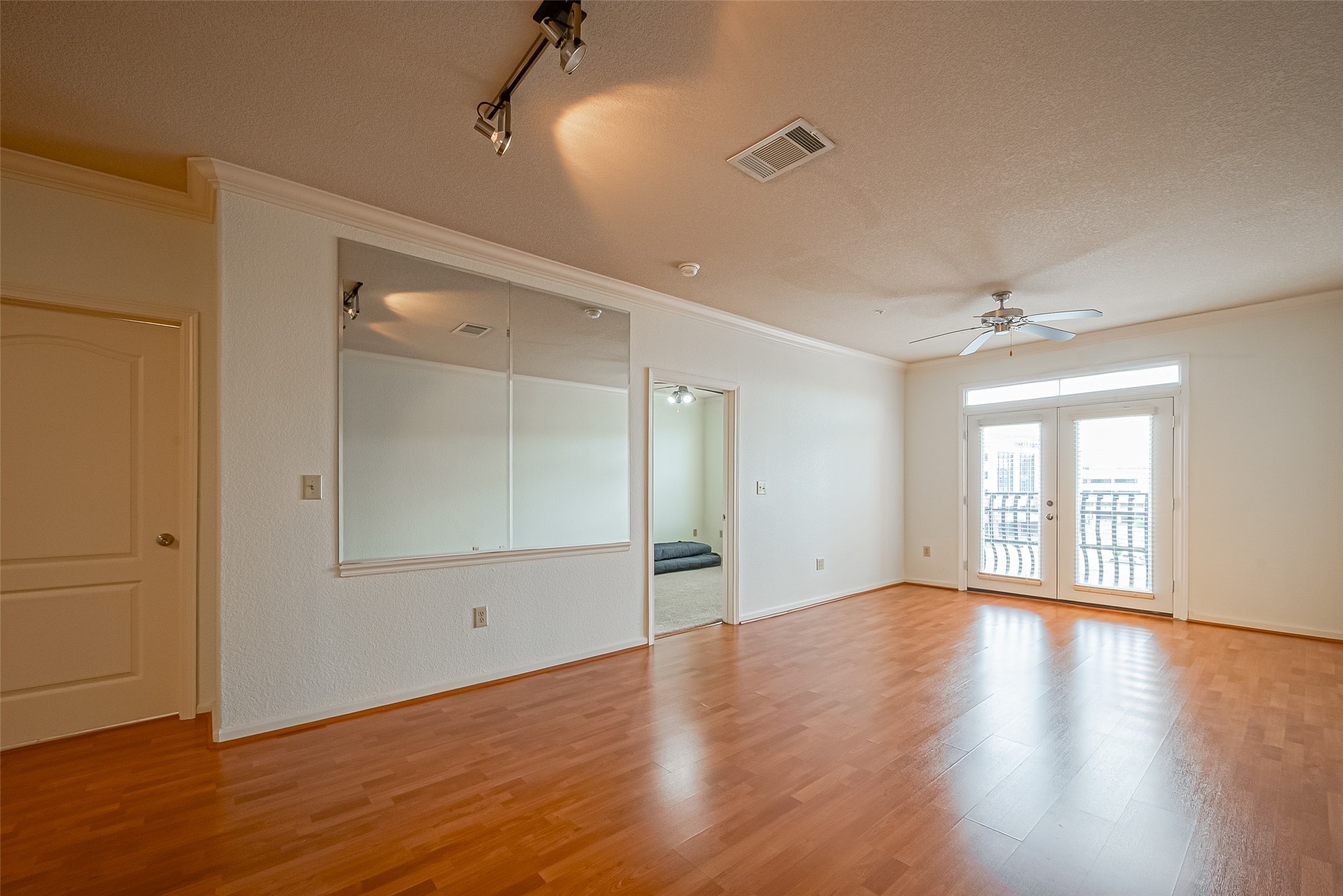 1711 Old Spanish Trail, Unit 303 Houston, TX 77054 - Photo 6 of 37 an empty room with wooden floor and windows