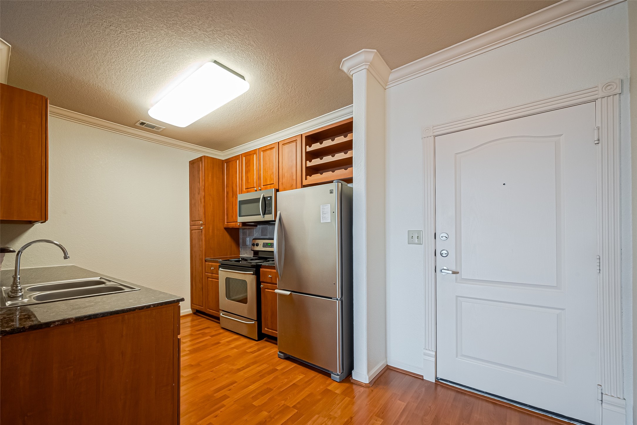 1711 Old Spanish Trail, Unit 303 Houston, TX 77054 - Photo 9 of 37 a kitchen with stainless steel appliances a refrigerator and a stove top oven
